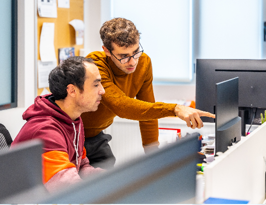 engineers-working-with-computer-in-a-cnc-modern-fa-2024-12-09-01-25-19-utc-1